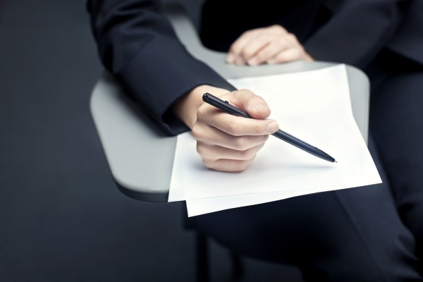 Close-up of business person with documents and pen