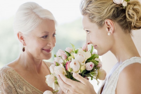 Mother and bride smelling bouquet