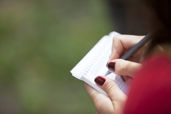 Woman writing on note pad, Canon 1Ds mark III