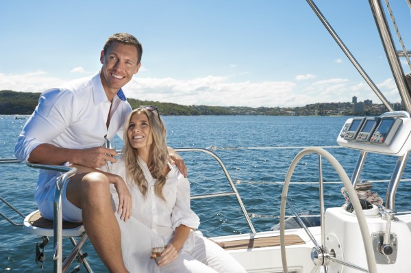 Couple in love sailing on a yacht drinking champagne
