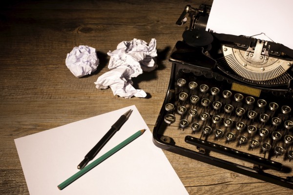 Vintage typewriter and a blank sheet of paper