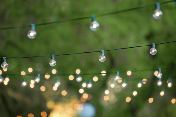 Hanging decorative christmas lights for a back yard party