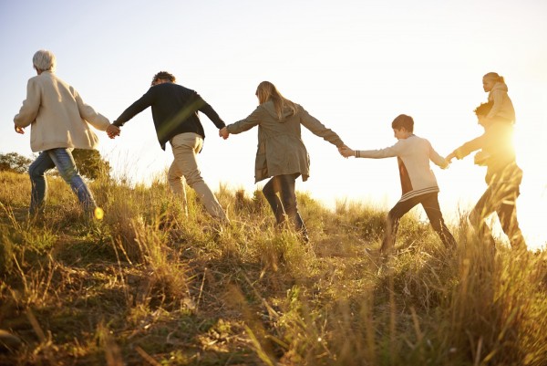 Shot of a happy family holding hands on a morning walk together