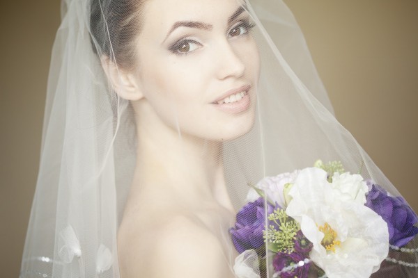 Portrait of a fresh and lovely bride wearing veil and smiling