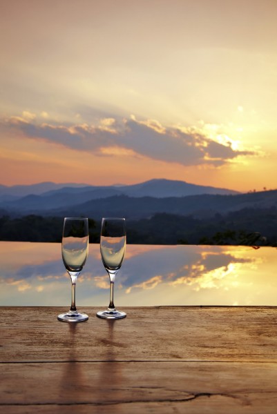 champagne glass on mountain background in sunset