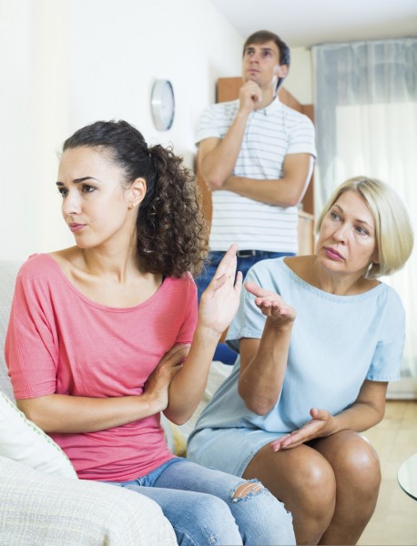 Adult girl having quarrel with husband and mother-in-law