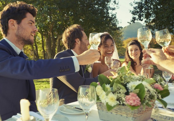 Shot of guests toasting the bride and groom at a wedding reception