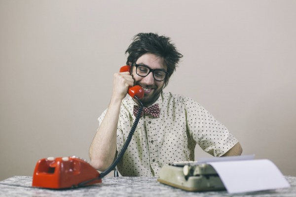 Nerd writer talking on phone