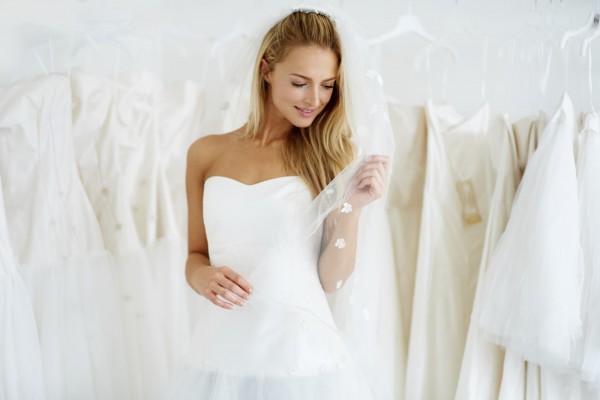 A young bride trying on her wedding dress - Copyspace