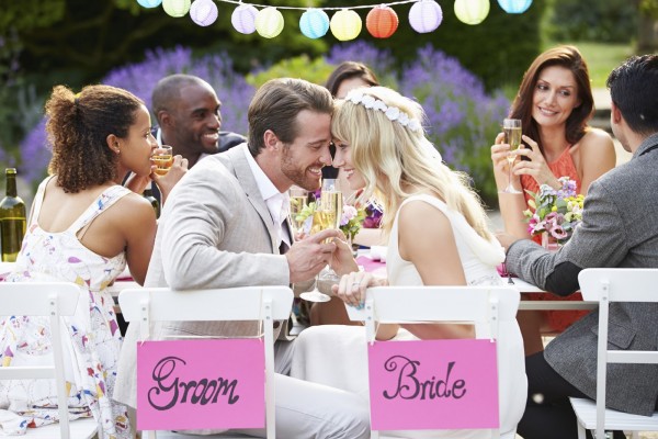 Bride And Groom Enjoying Meal At Wedding Reception