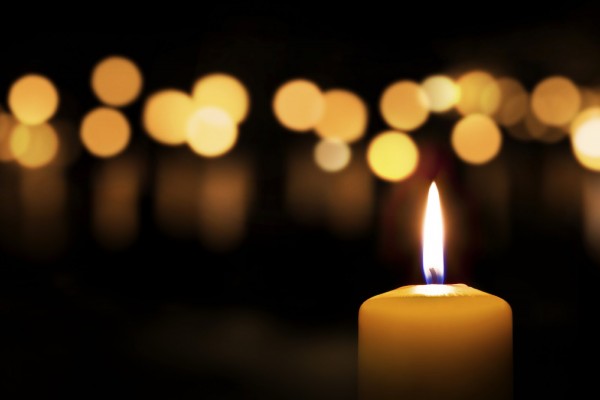 Three candles on dark background