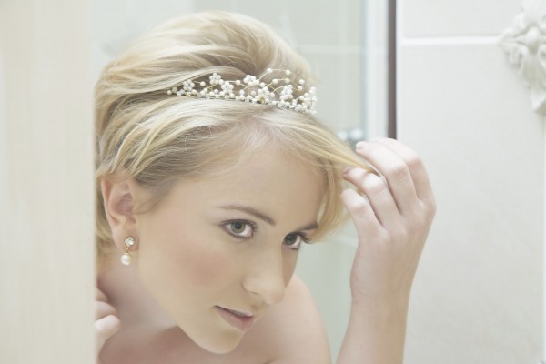 Reflection of a young bride fixing her hair