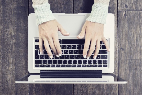 Woman typing on a laptop