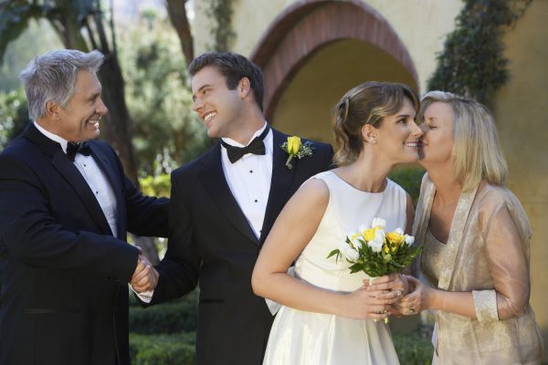 Bride, groom and parents exchanging wishes