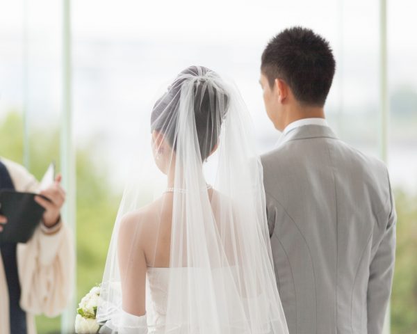 Man and woman getting married in wedding ceremony