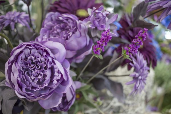 Colorful bouquet of artificial flowers with different blossoms