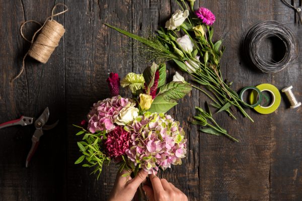 The florist desktop with working tools and ribbons