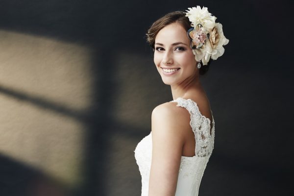 Glamorous young bride in wedding dress, smiling