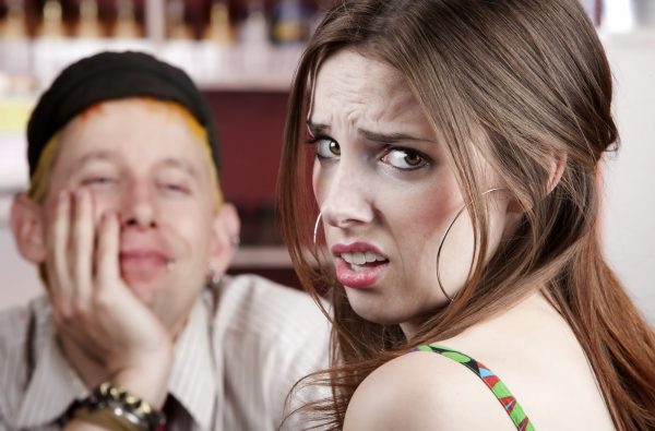 Young woman making an exasperated expression gesture on a bad date